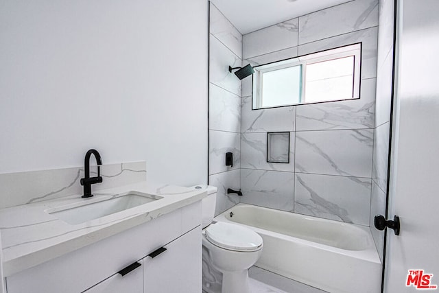 full bathroom featuring vanity, toilet, and tiled shower / bath