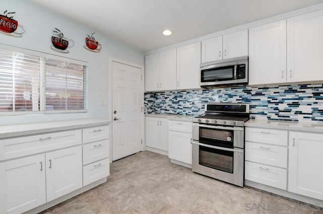 kitchen featuring backsplash, white cabinetry, and stainless steel appliances