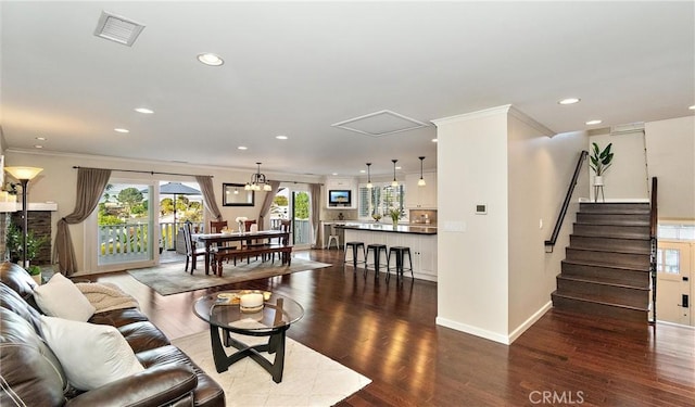 living room with dark wood-type flooring and ornamental molding