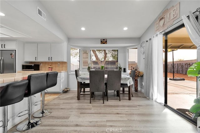 dining area featuring light wood-type flooring