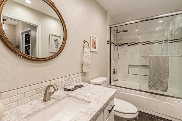 full bathroom with toilet, vanity, tile patterned flooring, and shower / bath combination with glass door