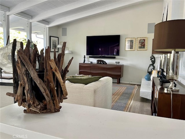 living room with beam ceiling and dark wood-type flooring