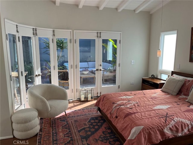 bedroom featuring lofted ceiling with beams, access to outside, and french doors