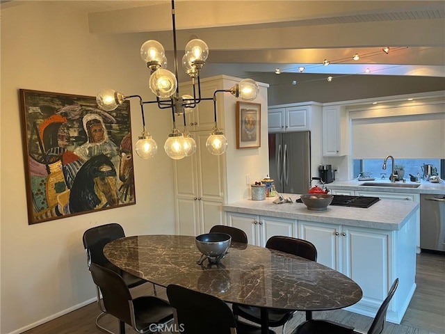 dining area with a chandelier, dark wood-type flooring, and sink