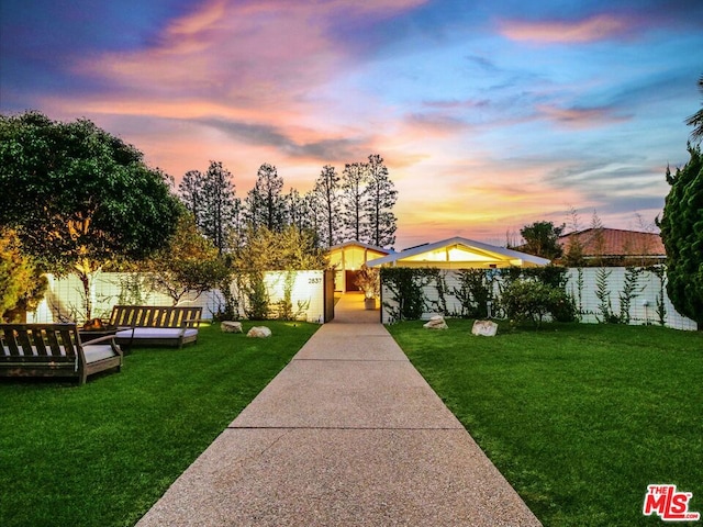 view of front of property with an outdoor hangout area and a yard