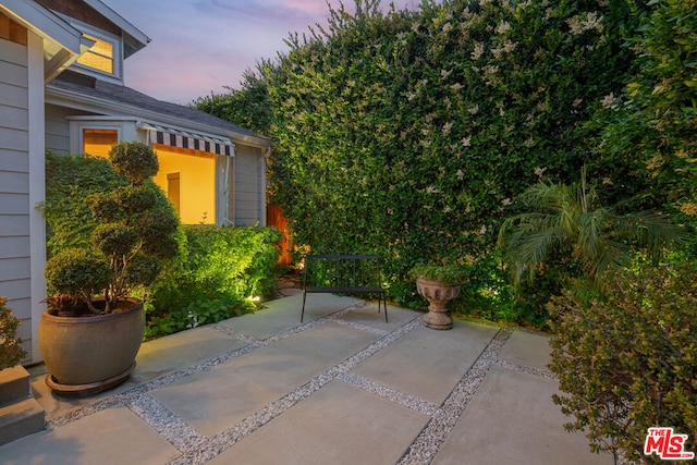 view of patio terrace at dusk