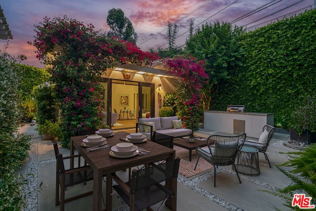 patio terrace at dusk with an outdoor living space