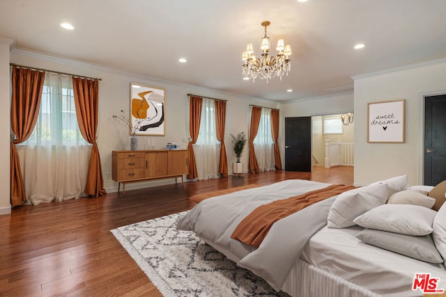 bedroom featuring crown molding, dark hardwood / wood-style floors, and an inviting chandelier