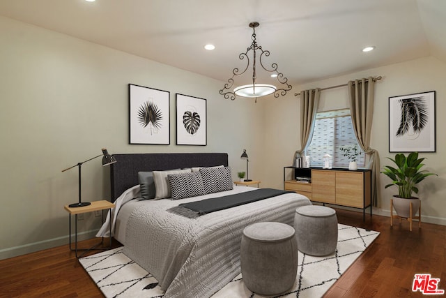 bedroom with dark hardwood / wood-style floors