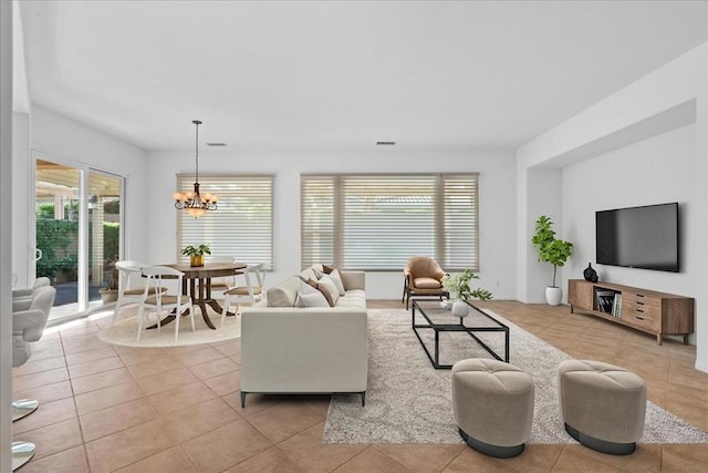 tiled living room featuring a chandelier