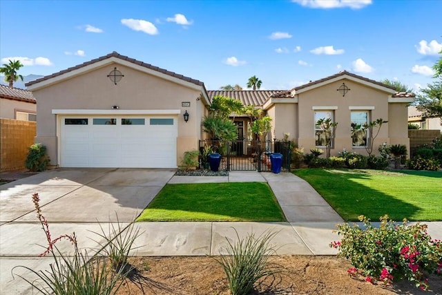 view of front of home with a front yard and a garage