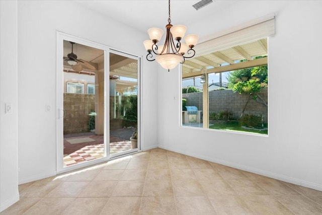 unfurnished dining area with ceiling fan with notable chandelier and light tile patterned flooring