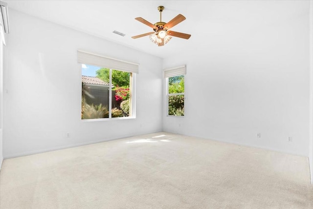 spare room with light carpet and ceiling fan