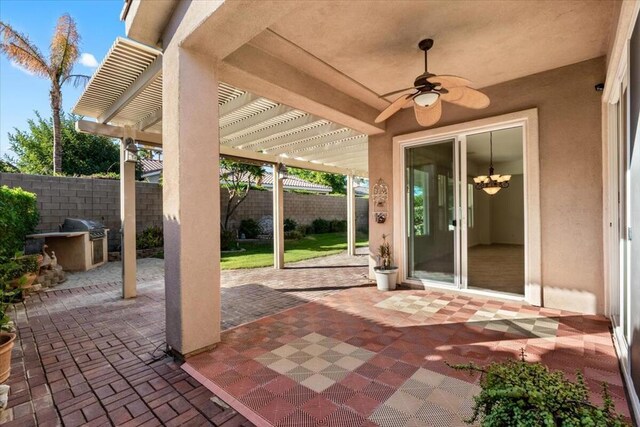 view of patio / terrace featuring a pergola, a grill, ceiling fan, and exterior kitchen