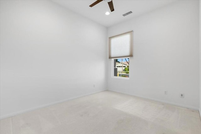 carpeted spare room with ceiling fan