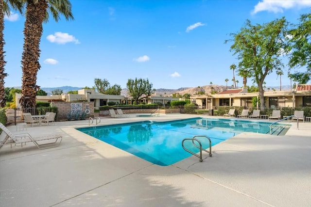 view of pool with a patio area and a mountain view