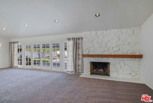 unfurnished living room featuring carpet and a stone fireplace