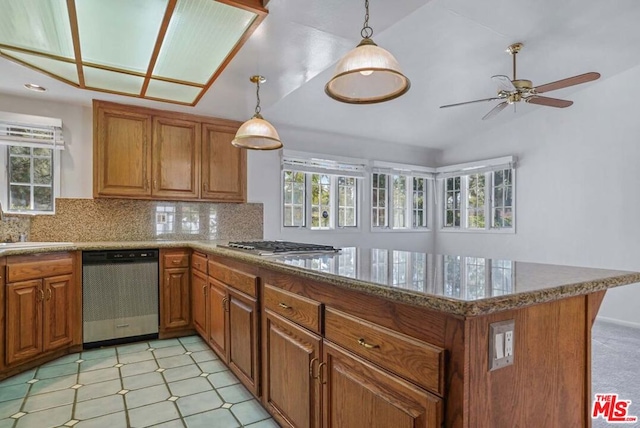 kitchen with kitchen peninsula, plenty of natural light, and appliances with stainless steel finishes