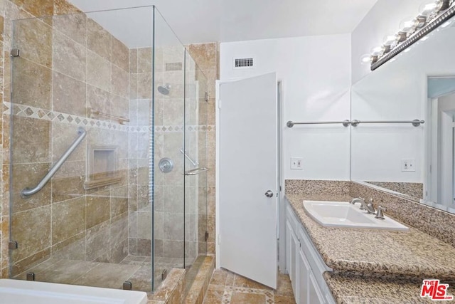 bathroom with vanity and an enclosed shower