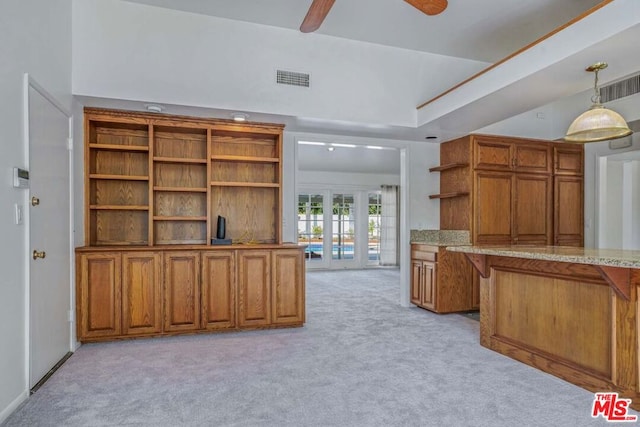 kitchen featuring light carpet, french doors, ceiling fan, and pendant lighting