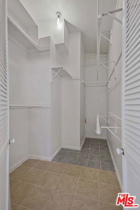 spacious closet featuring tile patterned floors