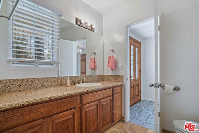 bathroom featuring tile patterned flooring, vanity, and a wealth of natural light