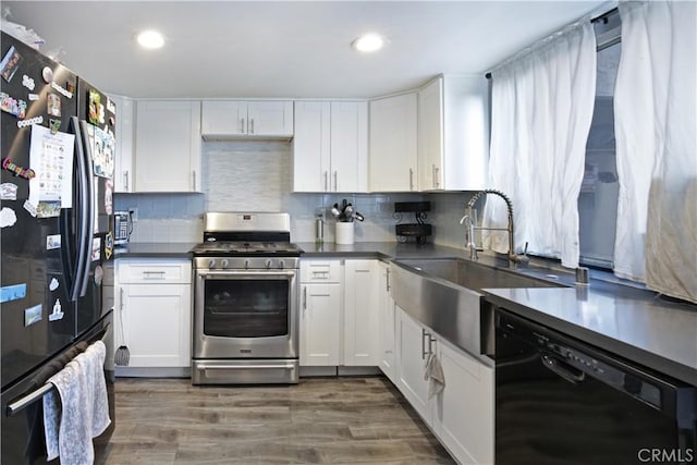 kitchen with white cabinetry, dark hardwood / wood-style floors, black appliances, and tasteful backsplash