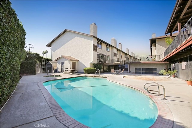 view of swimming pool with a patio