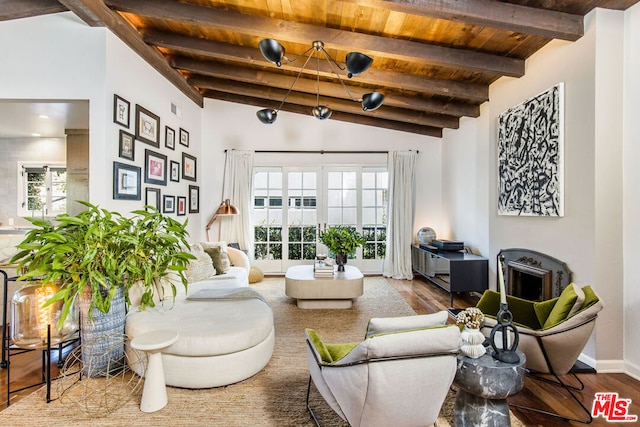 living room with vaulted ceiling with beams, hardwood / wood-style floors, and wooden ceiling