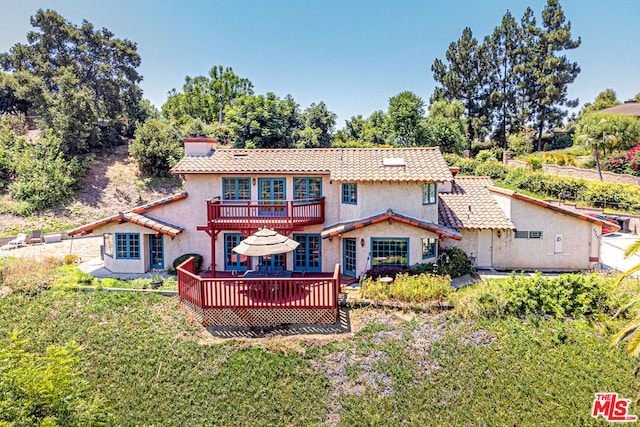 rear view of property with a deck