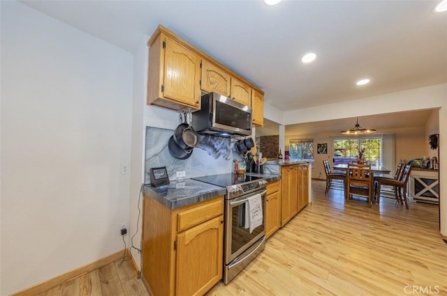 kitchen featuring appliances with stainless steel finishes and light hardwood / wood-style flooring