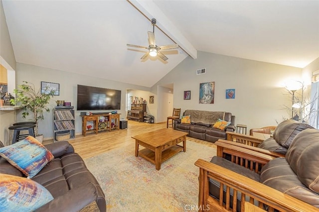 living room with vaulted ceiling with beams, ceiling fan, and light hardwood / wood-style floors