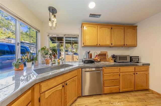 kitchen with dishwasher, decorative light fixtures, light hardwood / wood-style floors, and sink