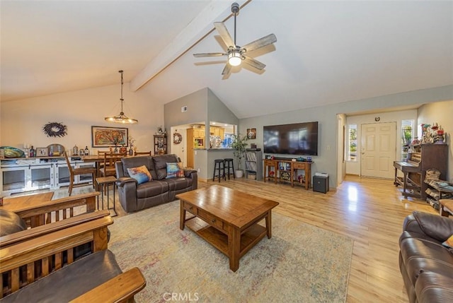 living room featuring beamed ceiling, light hardwood / wood-style floors, high vaulted ceiling, and ceiling fan