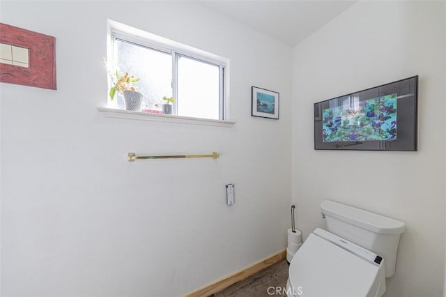 bathroom with hardwood / wood-style flooring and toilet