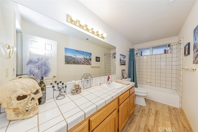 full bathroom with wood-type flooring, vanity, toilet, and shower / bath combo