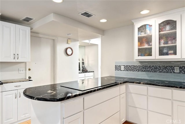 kitchen with kitchen peninsula and white cabinetry