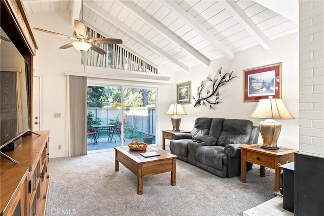 carpeted living room with beamed ceiling, high vaulted ceiling, and ceiling fan