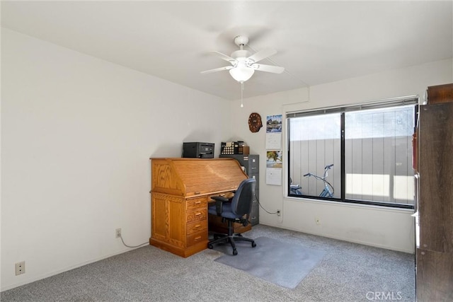 carpeted office space with ceiling fan