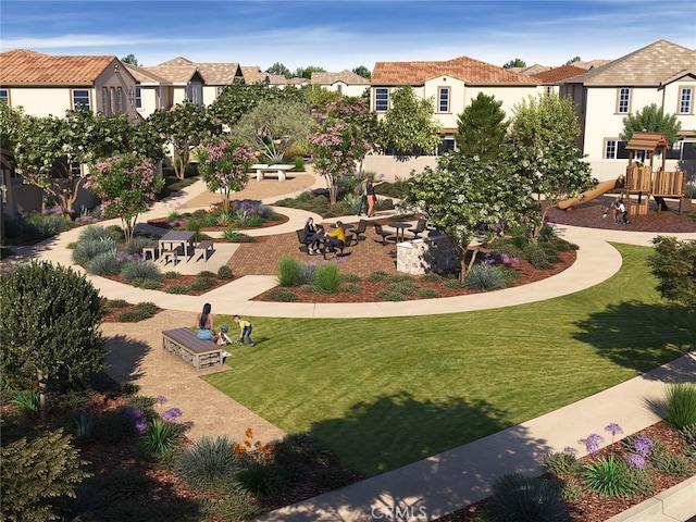 view of community featuring a playground and a yard