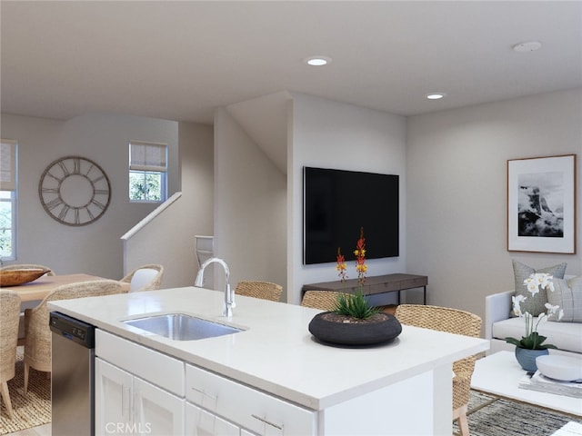 kitchen with white cabinetry, dishwasher, a center island with sink, and sink