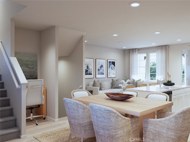 dining room featuring sink and light hardwood / wood-style floors