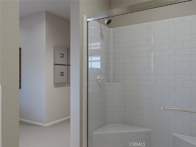 bathroom with a shower with door