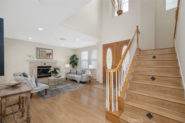 interior space featuring light wood-type flooring and a high end fireplace