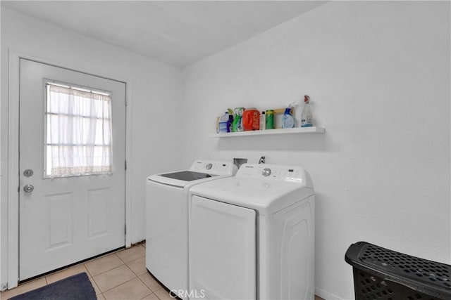 laundry area featuring separate washer and dryer and light tile patterned floors