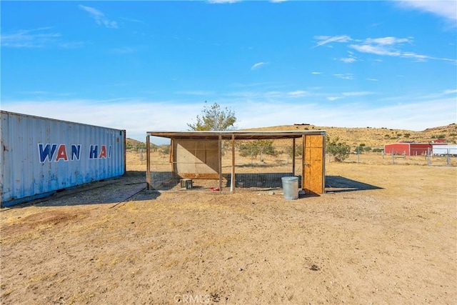 view of outbuilding featuring a rural view