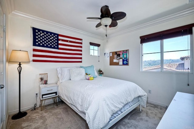 bedroom featuring ceiling fan, carpet floors, and crown molding