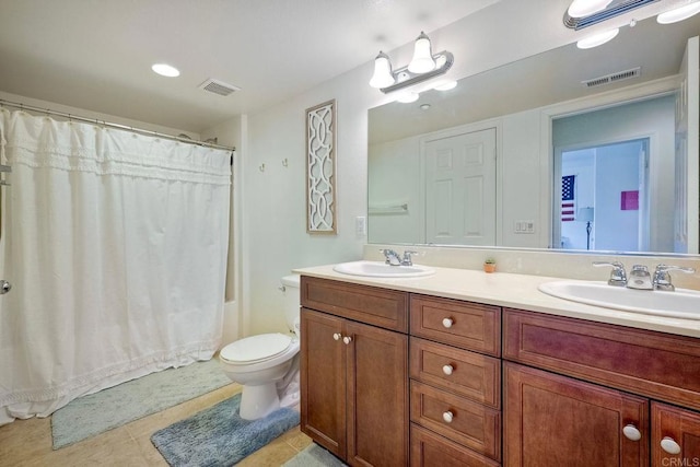 bathroom featuring tile patterned flooring, vanity, and toilet