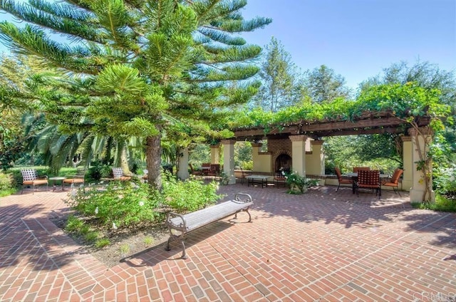 view of patio / terrace featuring a pergola and an outdoor fireplace