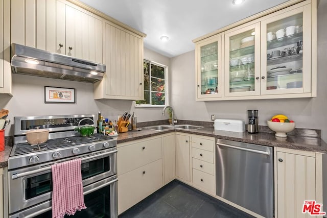 kitchen featuring sink, appliances with stainless steel finishes, and cream cabinets